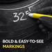 Hand with a yellow marker writing on a tire with text '32' and 'E1'.